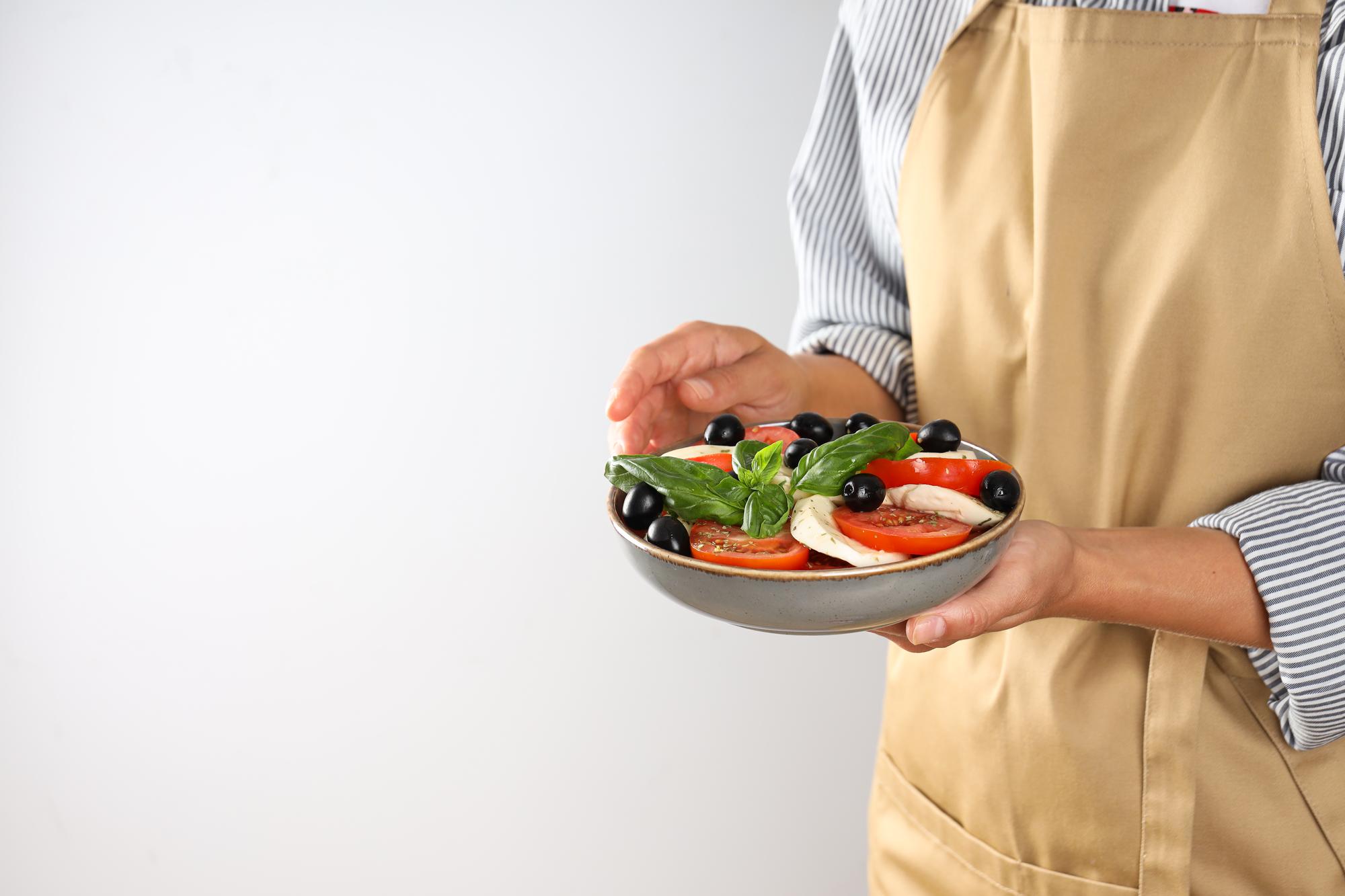 Chef handing over a prepared meal to a customer